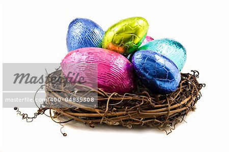 Colorful easter eggs in a nest on a white background