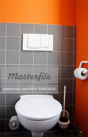 toilet bowl with black and orange wall for copyspace