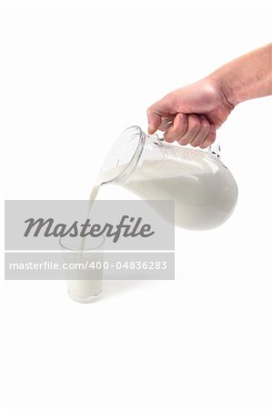 man hand pours milk isolated on white