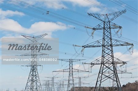 A long line of electrical transmission towers carrying high voltage lines.