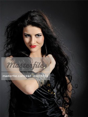 Beautiful woman with long black healthy hair in arabic traditional clothes