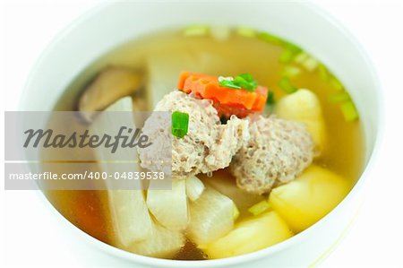 Vegetable soup with pork in white bowl