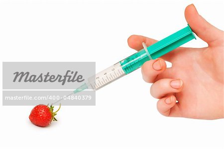 Hand with syringe and red strawberry on white
