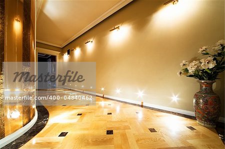 flowers in a long hallway with parquet flooring