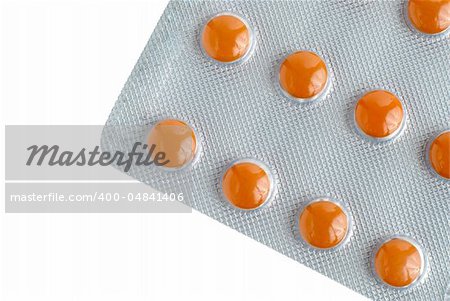 Close-up of a pack of orange pills on white background.