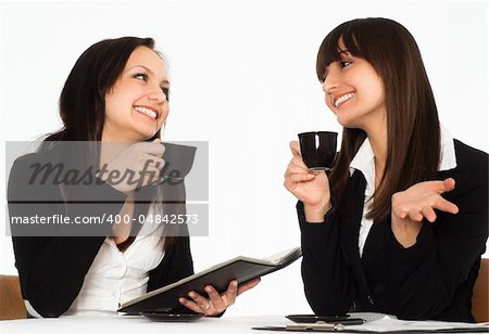 two beautiful business women sitting at the table