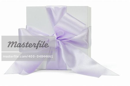 Gift box with large purple ribbon lying on its side