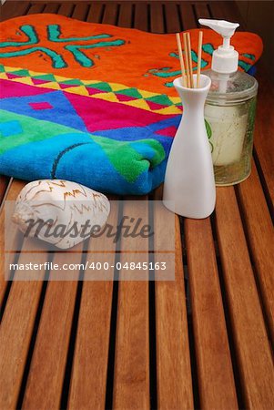Spa concept of brown color: the towel, soap and candles over sisal background