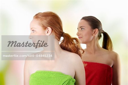 Spa - portrait of two woman - redhead and brunette - looking left