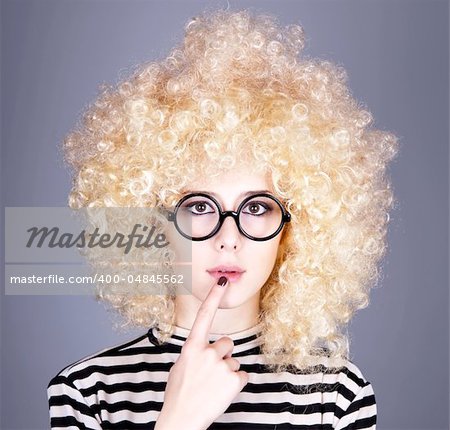 Portrait of funny girl in blonde wig. Studio shot.