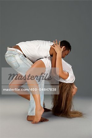 Young couple dances Caribbean Salsa, studio shot