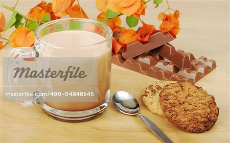 Hot Chocolate in Glass with Chocolate Chip Cookies and Chocolate Bar on wooden board (Selective Focus)