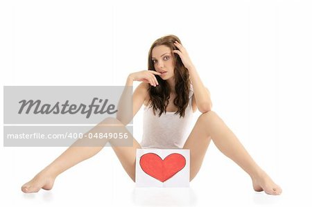 young woman sitting on the floor with painted hearts isolated on white