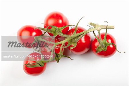 some cherry tomatoes connected together on ther stem