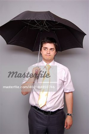 Man under umbrella. Studio shot.