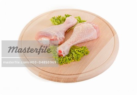 Fresh raw chicken legs on wooden board, clipping path included