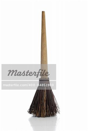 Broom on white background with shadow reflection.