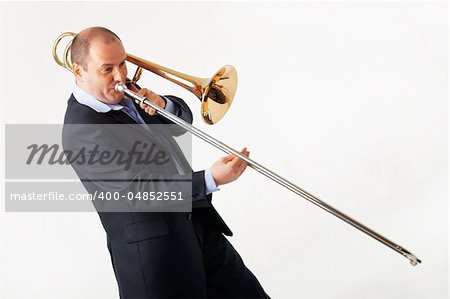 Portrait of a young man playing his trombone.