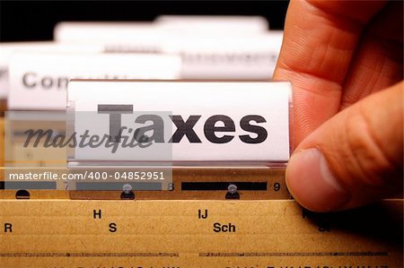 tax or taxes concept with word on business folder index