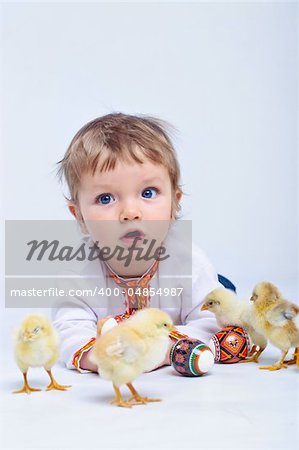 Cute little boy in embroidered with Easter eggs and easter chicks