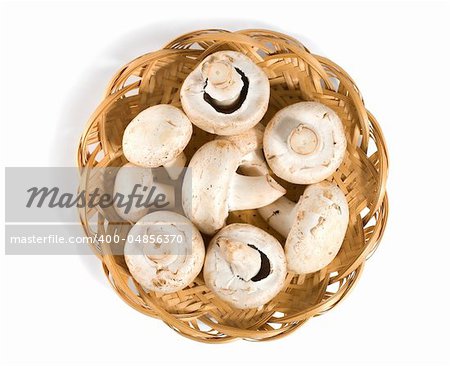 Mushrooms in a wooden basket isolated on a white background
