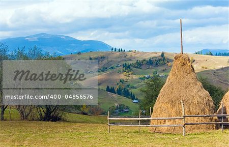 Autumn countryside landscape with village on mountainside