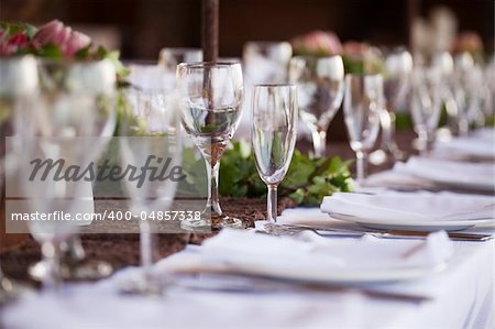 Wedding decor, wine glasses and champagne flutes on table. Selective focus