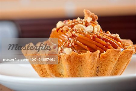 fresh baked cupcake with nuts on a wooden table