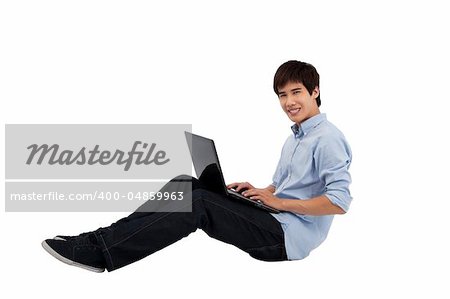 young man using laptop on the floor