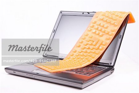 laptop and flexible orange keyboard isolated