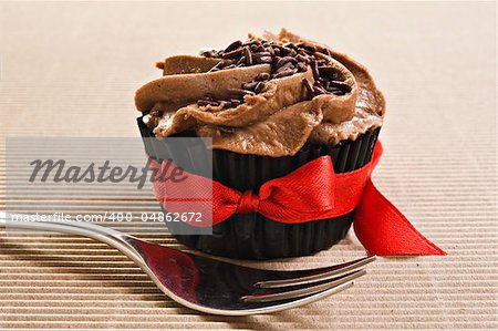 Cup cake with red bow and fork