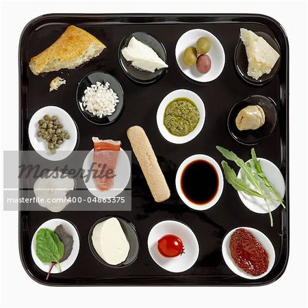 various types of italian snacks on black plate