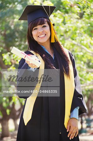 Stock image of happy female graduate, outdoor setting