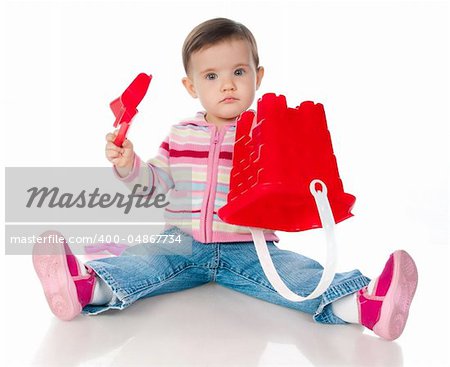 little kid playing with colorful toys on a white background