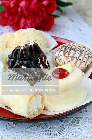 several kinds of cakes on a special stand dessert plates