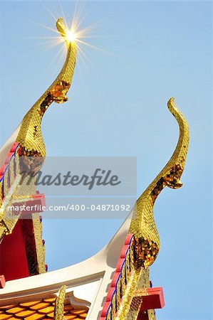 detail of ornately decorated temple roof in bangkok, thailand