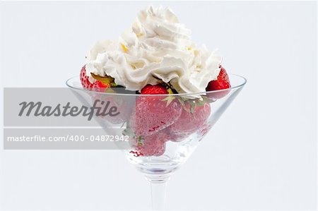 Strawberries with creme in a cup isolated on white background