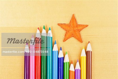 Orange Star with Colored Pencils on Table