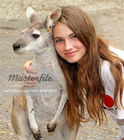 young girl hugging a kangaroo.