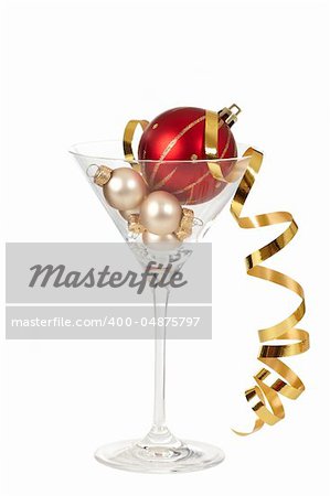 christmas decorations in martini glass on white background