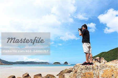 Photographer taking photo on beach