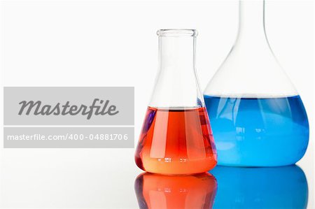 Blue and red beakers against a white background