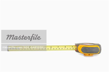 Yellow measuring tape partly unrolled against a white background
