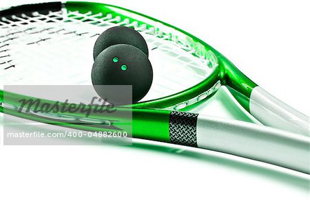 Green squash racket with balls on white background with space for text