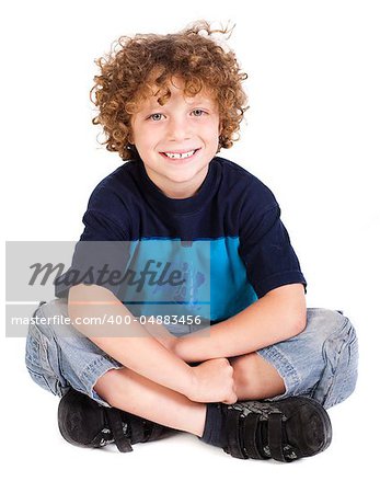 Cheerful kid relaxing on floor isolated against on white.
