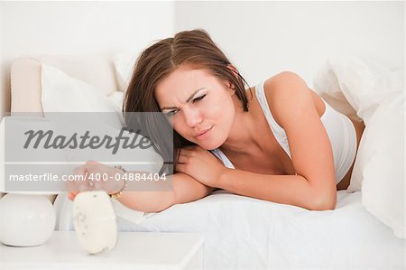 Cute woman waking up in her bedroom