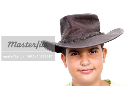 Young cowboy smiling, looking at camera, on white background