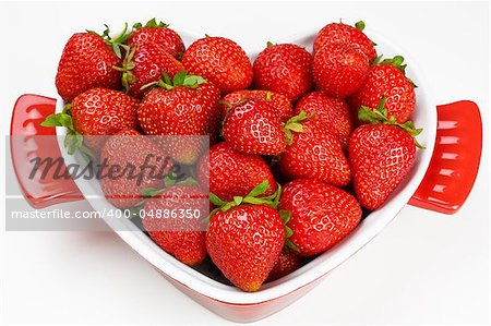 Ripe fresh strawberry in bowl form the heart