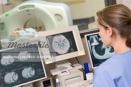 Nurse Monitoring Patient Having A Computerized Axial Tomography (CAT) Scan