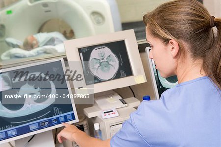 Nurse Monitoring Patient Having A Computerized Axial Tomography (CAT) Scan